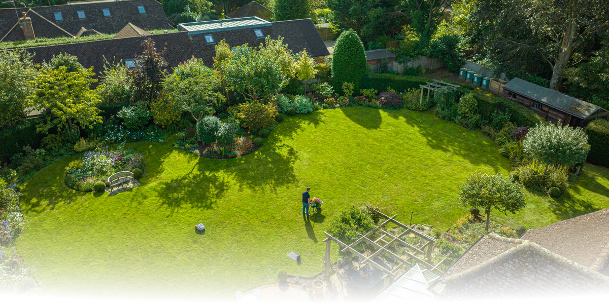 Navimow robot mower covering a backyard lawn