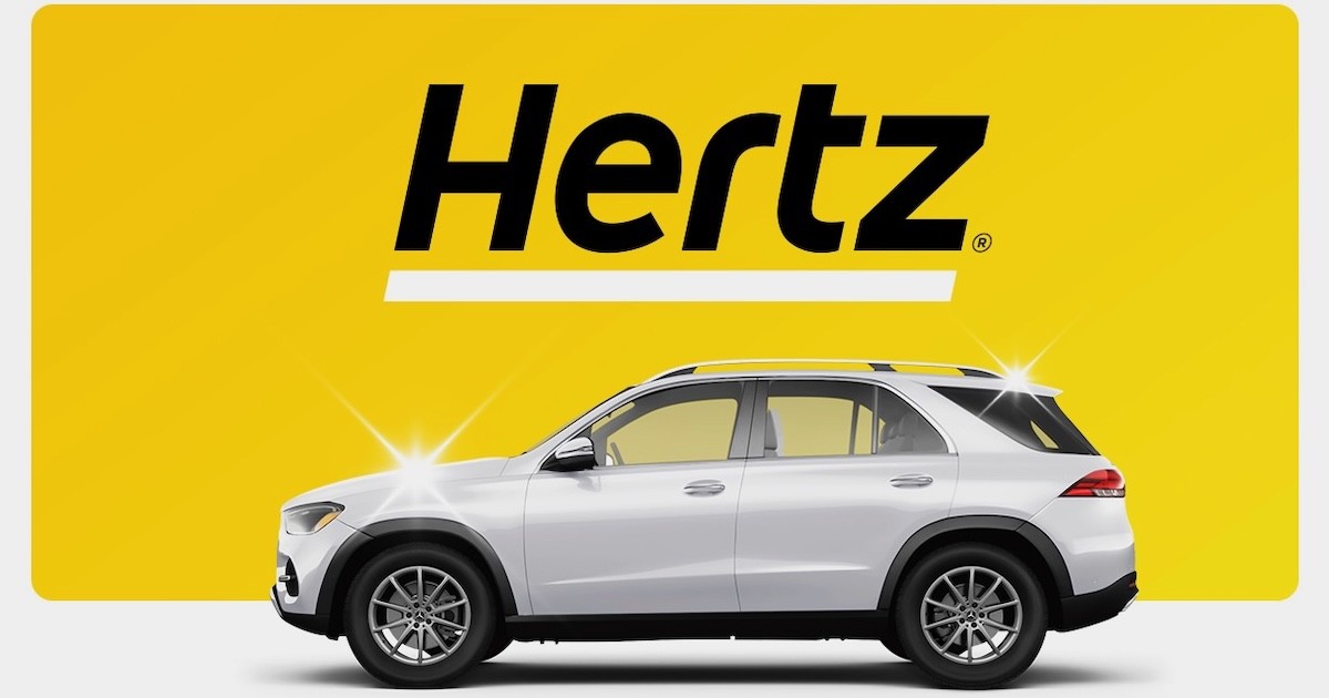 Hertz rental SUV on the official Hertz yellow brand background