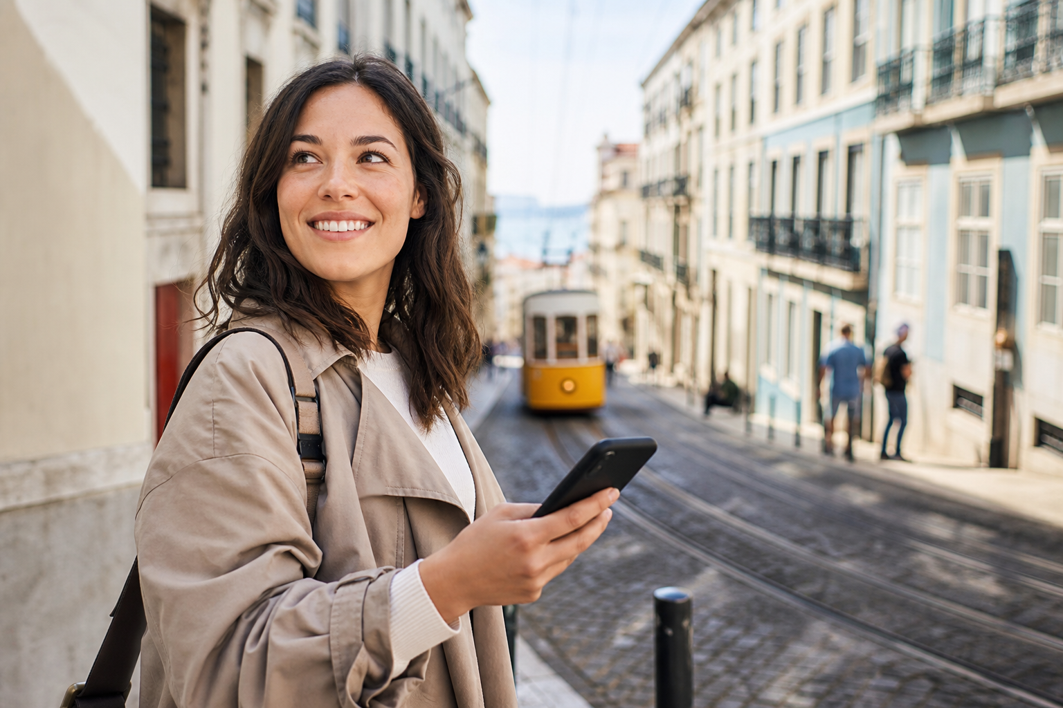 Traveler using a smartphone on a city street abroad